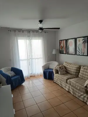 a living room with two couches and a tile floor at Oasis Flamencos Golf in Sanlúcar de Barrameda