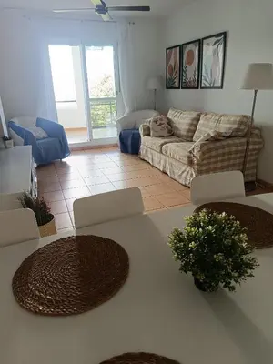 a living room with a couch and a table at Oasis Flamencos Golf in Sanlúcar de Barrameda