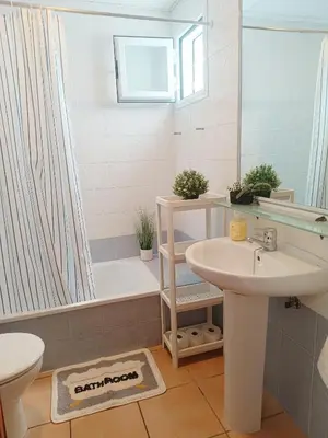 a bathroom with a sink and a shower and a toilet at Oasis Flamencos Golf in Sanlúcar de Barrameda