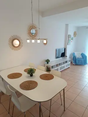 a white table and chairs in a living room at Oasis Flamencos Golf in Sanlúcar de Barrameda