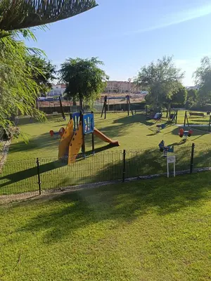 a playground with a slide in a park at Oasis Flamencos Golf in Sanlúcar de Barrameda