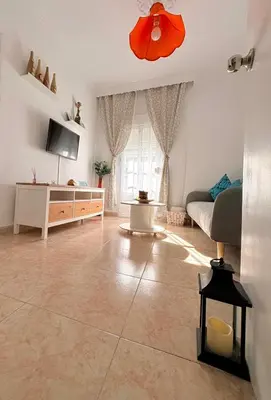 a room with a white cabinet and a white refrigerator at El rincón de Nai in Chiclana de la Frontera