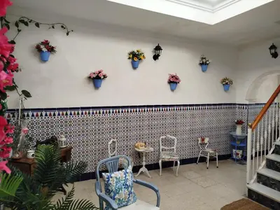 a room with chairs and a couch and a table at El rincón de Nai in Chiclana de la Frontera