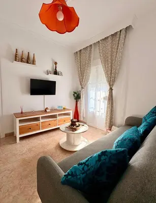 a living room with a couch and a tv at El rincón de Nai in Chiclana de la Frontera