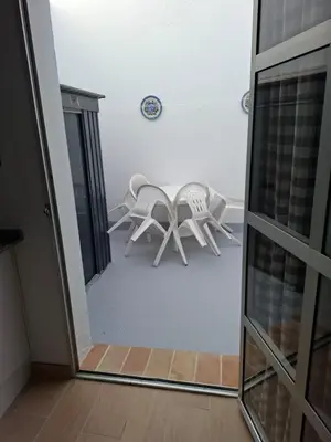 a mirror reflection of a chair in a room at Apartamento Las Arenas in Chiclana de la Frontera