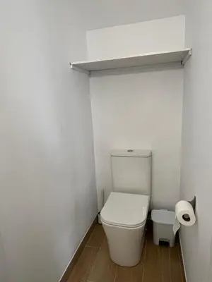 a bathroom with a toilet and a roll of toilet paper at Apartamento Las Arenas in Chiclana de la Frontera