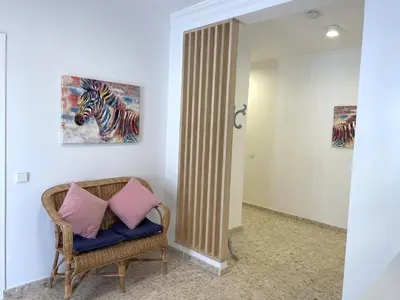 a room with a chair and a painting of a zebra at Casa Elena in Conil de la Frontera