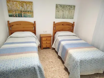 two beds sitting next to each other in a bedroom at Casa Elena in Conil de la Frontera