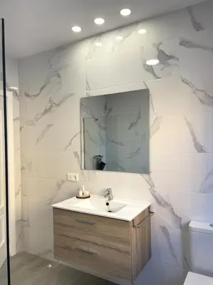 a bathroom with a sink and a mirror at Casa Elena in Conil de la Frontera