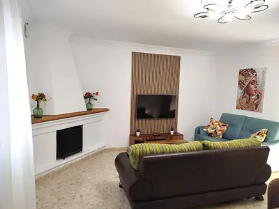a living room with a couch and a television at Casa Elena in Conil de la Frontera