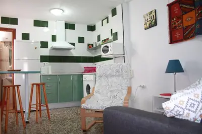 a living room with a couch and a kitchen at Casa Lomas in Arcos de la Frontera