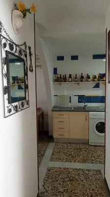 a kitchen with a sink and a washing machine at Casa Lomas in Arcos de la Frontera