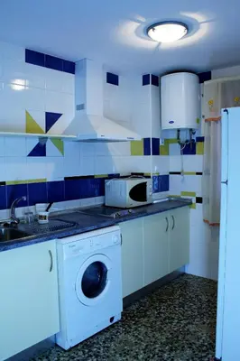 a kitchen with a washing machine and a sink at Casa Lomas in Arcos de la Frontera