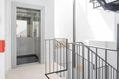 a staircase in a building with a glass door at Sanlucar Centro - Apartamento 1 in Sanlúcar de Barrameda