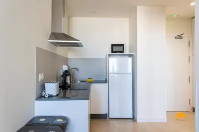 a kitchen with a refrigerator and a sink at Delfin Azul 2 FREE PARKING by Cadiz Time in Cádiz