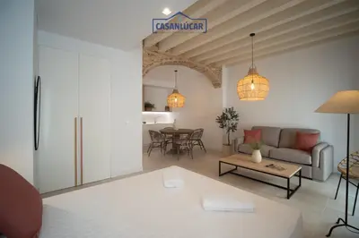 a living room with a couch and a table at Sanlucar Centro - Apartamento 2 in Sanlúcar de Barrameda
