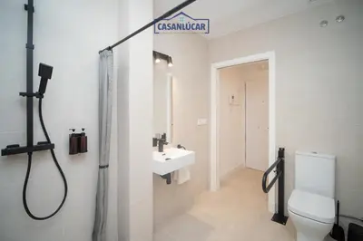 a bathroom with a shower and a toilet and a sink at Sanlucar Centro - Apartamento 2 in Sanlúcar de Barrameda