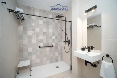 a bathroom with a sink and a shower at Sanlucar Centro - Apartamento 2 in Sanlúcar de Barrameda