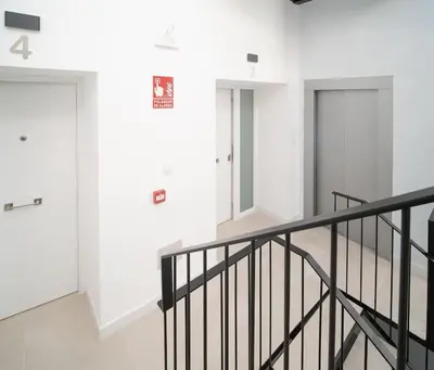 a staircase in a building with three doors at Sanlucar Centro - Apartamento 3 in Sanlúcar de Barrameda