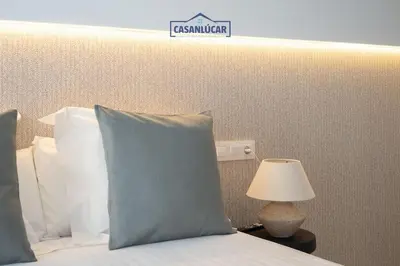a bedroom with a bed with a sign on the wall at Sanlucar Centro - Apartamento 3 in Sanlúcar de Barrameda