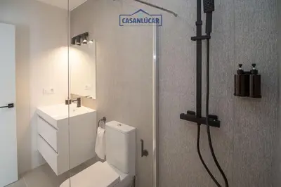 a bathroom with a toilet and a sink and a shower at Sanlucar Centro - Apartamento 3 in Sanlúcar de Barrameda