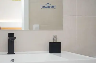 a bathroom sink with a faucet and a mirror at Sanlucar Centro - Apartamento 3 in Sanlúcar de Barrameda
