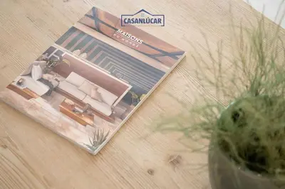 a magazine sitting on top of a wooden table at Sanlucar Centro - Apartamento 3 in Sanlúcar de Barrameda