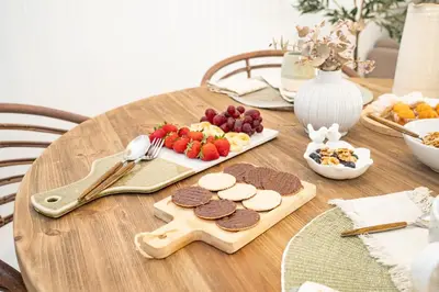 a wooden table with cookies and fruit on it at Sanlucar Centro - Apartamento 4 in Sanlúcar de Barrameda