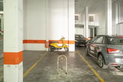 a parking garage with a scooter parked in it at Sanlucar Centro - Apartamento 4 in Sanlúcar de Barrameda