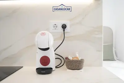 a white electric hair dryer sitting on a counter at Sanlucar Centro - Apartamento 5 in Sanlúcar de Barrameda