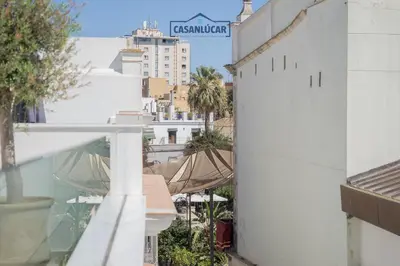 a view of a city from the balcony of a building at Sanlucar Centro - Apartamento 5 in Sanlúcar de Barrameda