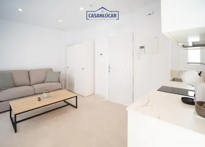 a living room with a couch and a coffee table at Sanlucar Centro - Apartamento 5 in Sanlúcar de Barrameda