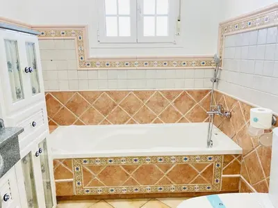 a bathroom with a bath tub with a sink at La Almadraba in Chiclana de la Frontera