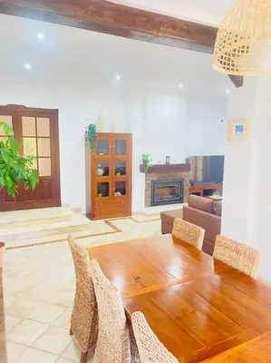 a living room with a wooden table and chairs at La Almadraba in Chiclana de la Frontera