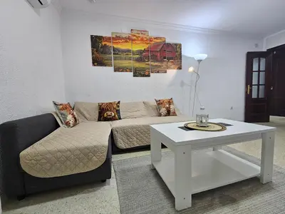 a living room with a couch and a table at Apartamento Granja - a 5 min de la playa in Cádiz