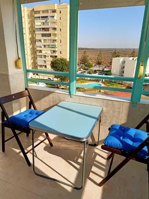 a table and two chairs on a balcony at Azvalia Puerto Príncipe 2 in El Puerto de Santa María