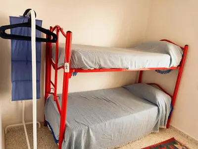 two bunk beds in a room next to a wall at Azvalia Puerto Príncipe 2 in El Puerto de Santa María