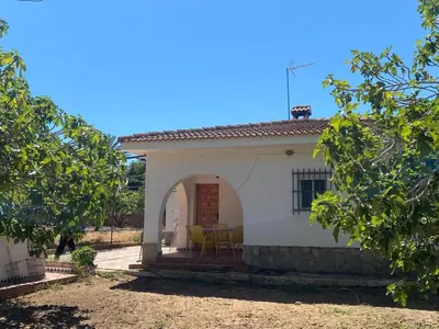 a small white house with a table and chairs at villa eloisa in Chiclana de la Frontera