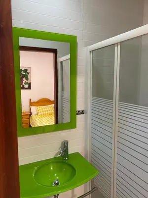 a bathroom with a green sink and a shower at villa eloisa in Chiclana de la Frontera