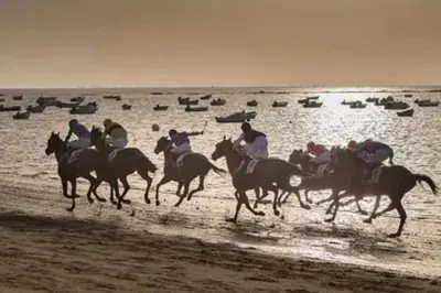 a group of people riding horses on the beach at Apartamento V CENTENARIO BEACH Sanlúcar in Sanlúcar de Barrameda