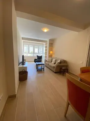a living room with a couch and a table at Delfín Avenida Ha in Cádiz