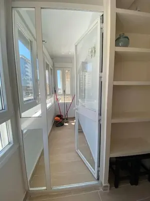 a room with a large glass door in a room at Delfín Avenida Ha in Cádiz