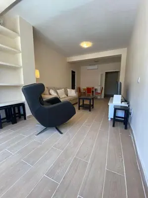 a living room with a black chair and a couch at Delfín Avenida Ha in Cádiz