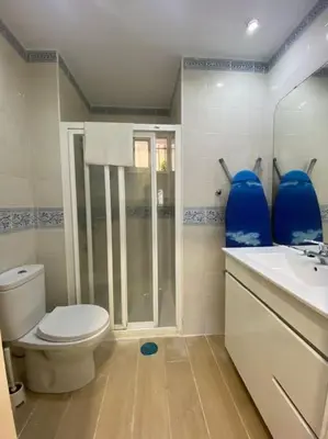 a bathroom with a toilet and a shower and a sink at Delfín Avenida Ha in Cádiz