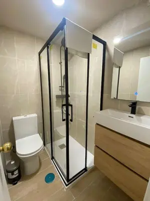 a bathroom with a shower and a toilet and a sink at Delfín Avenida Ha in Cádiz