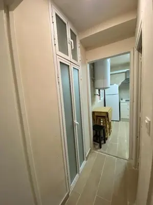 a hallway with a door to a room with a table at Delfín Avenida Ha in Cádiz