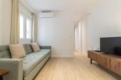 a living room with a couch and a flat screen tv at Allo Apartments Morenos IV Bajo B Centro 2 Habitaciones in Jerez de la Frontera