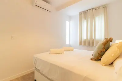 a bedroom with a bed with a stuffed animal on it at Allo Apartments Morenos IV Bajo B Centro 2 Habitaciones in Jerez de la Frontera
