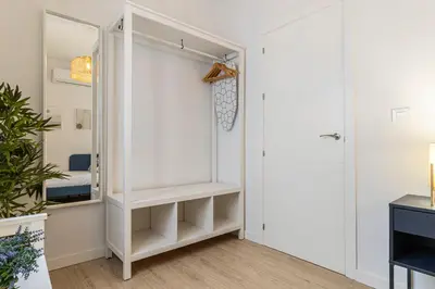 a closet with white shelves and a mirror at Allo Apartments Morenos IV Bajo B Centro 2 Habitaciones in Jerez de la Frontera