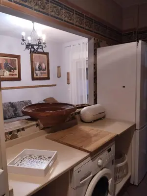 a bathroom with a sink and a washing machine at Bienvenidos Villa Roki Para información seis3tres 0nueve 0nueve veinte in El Puerto de Santa María
